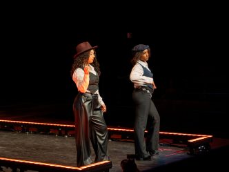 Two women posed at the end of a stage
