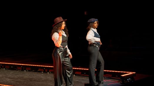 Two women posed at the end of a stage