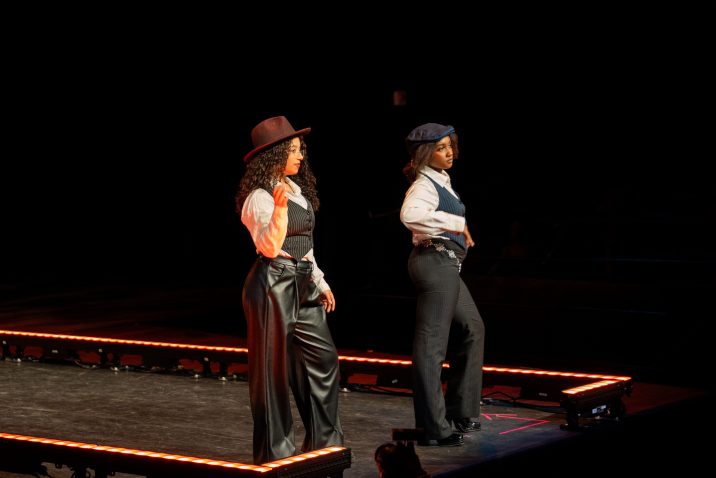 Two women posed at the end of a stage