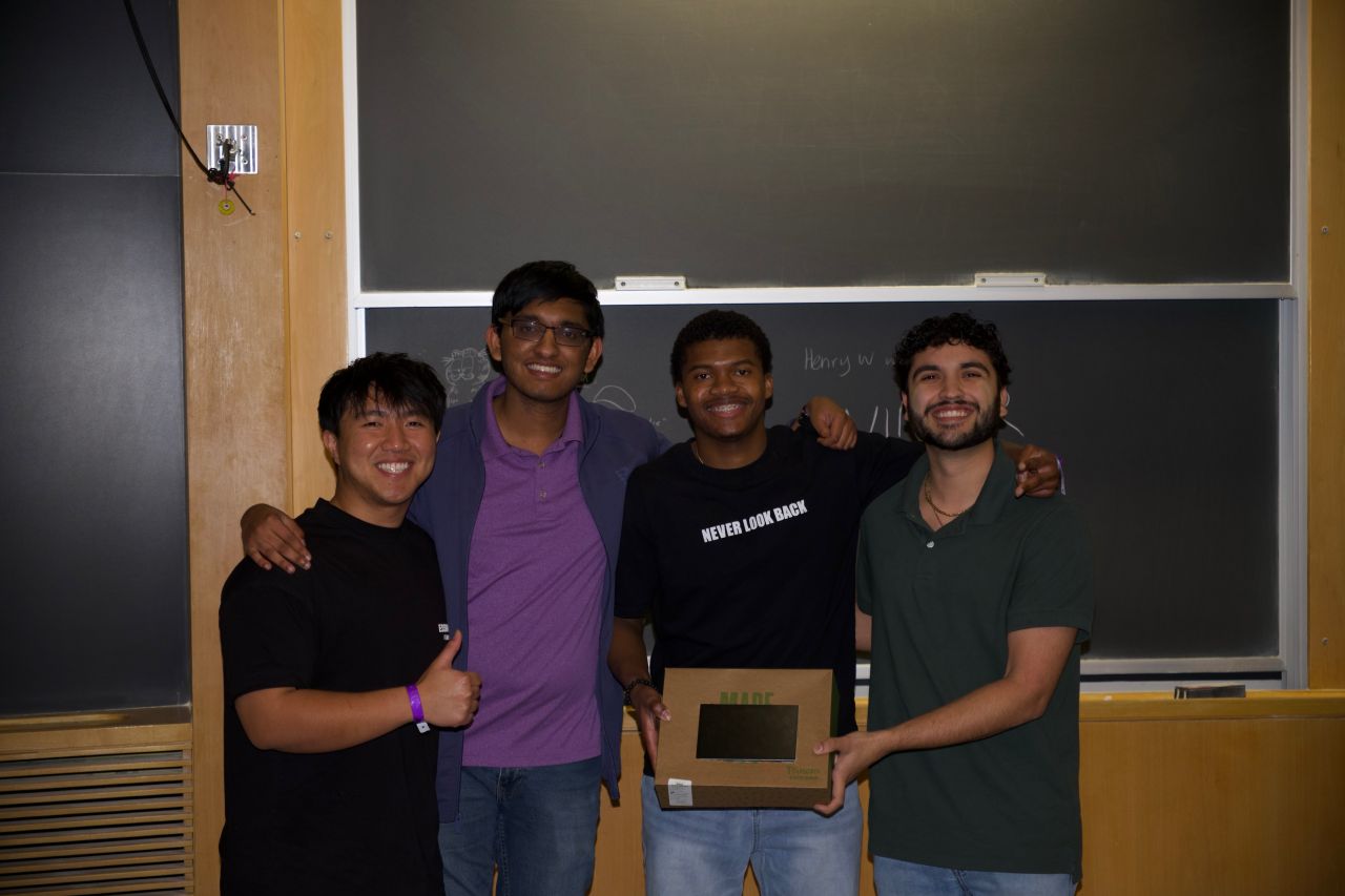 From left, Viet Nguyen, Aden Kallery, George Dorton and Christopher Guzman pose together in a classroom while holding their project following the competition.