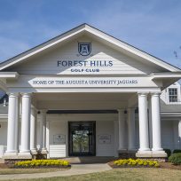 Front of building with new signage posted above the entry way