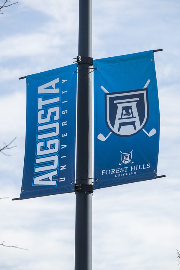 A light pole with Augusta University banners hanging on them