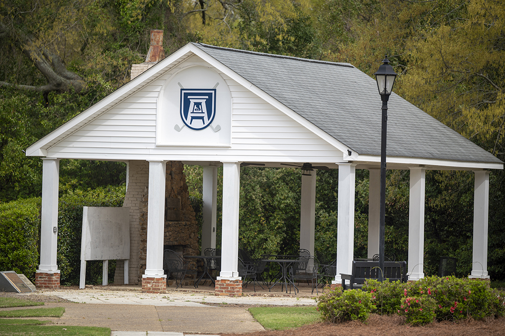 A covered patio with new logo on it