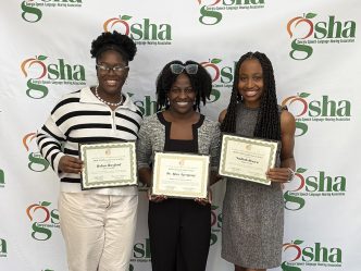 Three women standing with certificates.