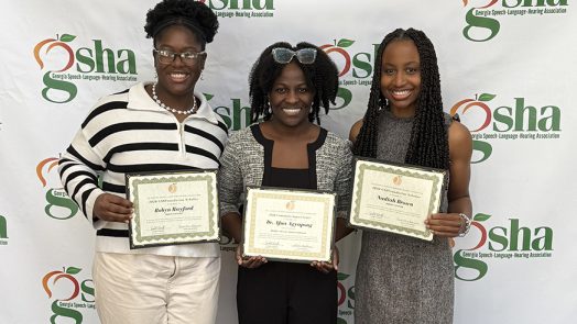 Three women standing with certificates.