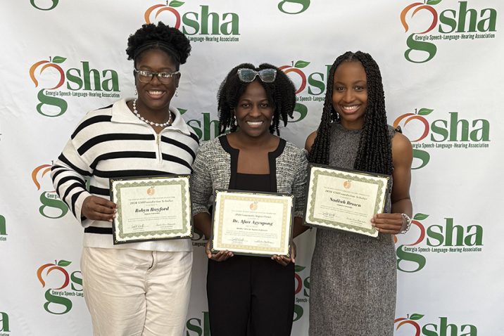 Three women standing with certificates.