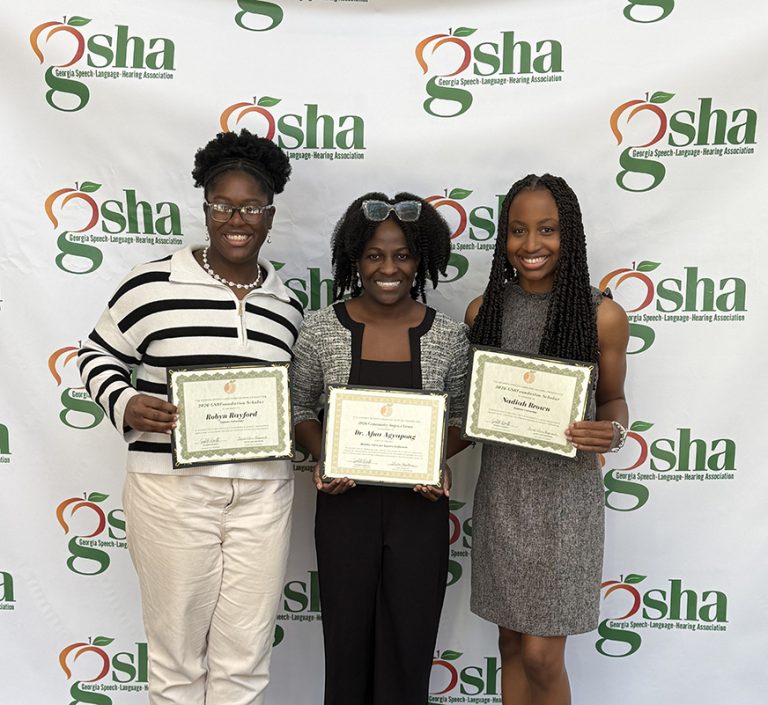 Three women standing with certificates.