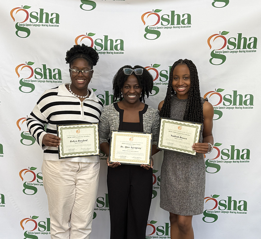 Three women standing with certificates.