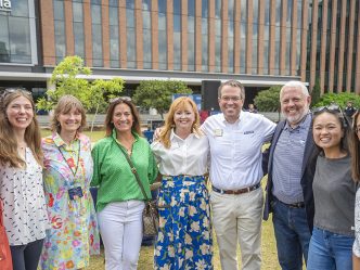 Smiling people outside on a college campus