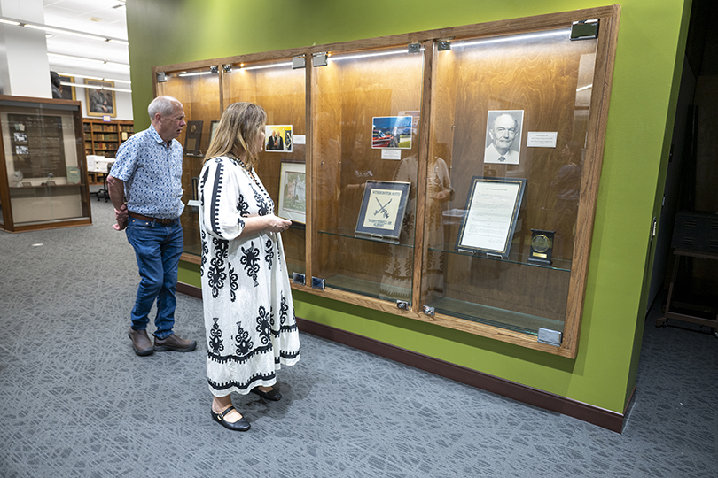 Man and woman looking at a display of memorabilia
