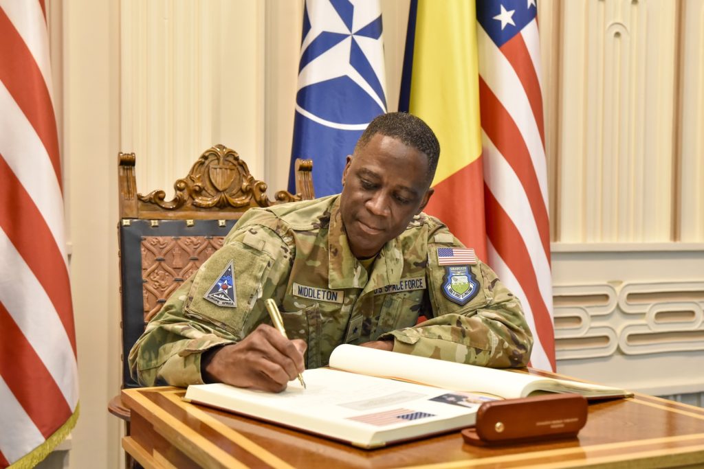 Brigadier General signing a document.