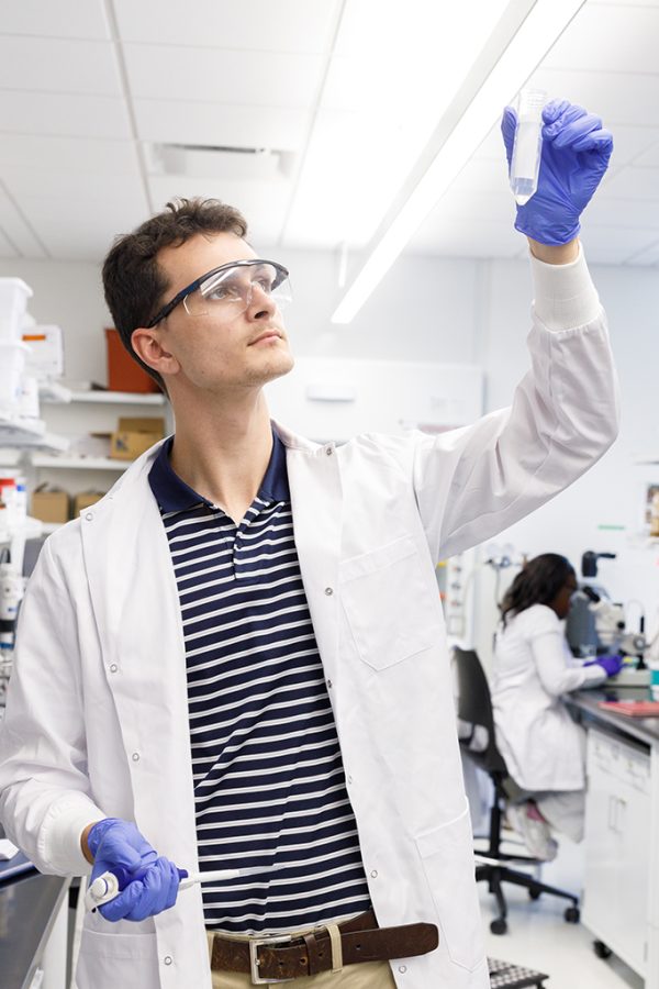 Man looking at a test tube