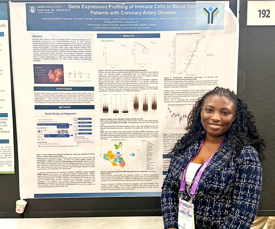 A woman stands beside her scientific poster during a poster session at a large conference.