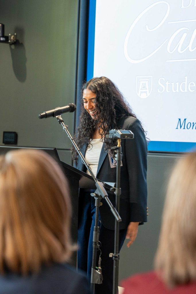 A girl speaking at a podium.