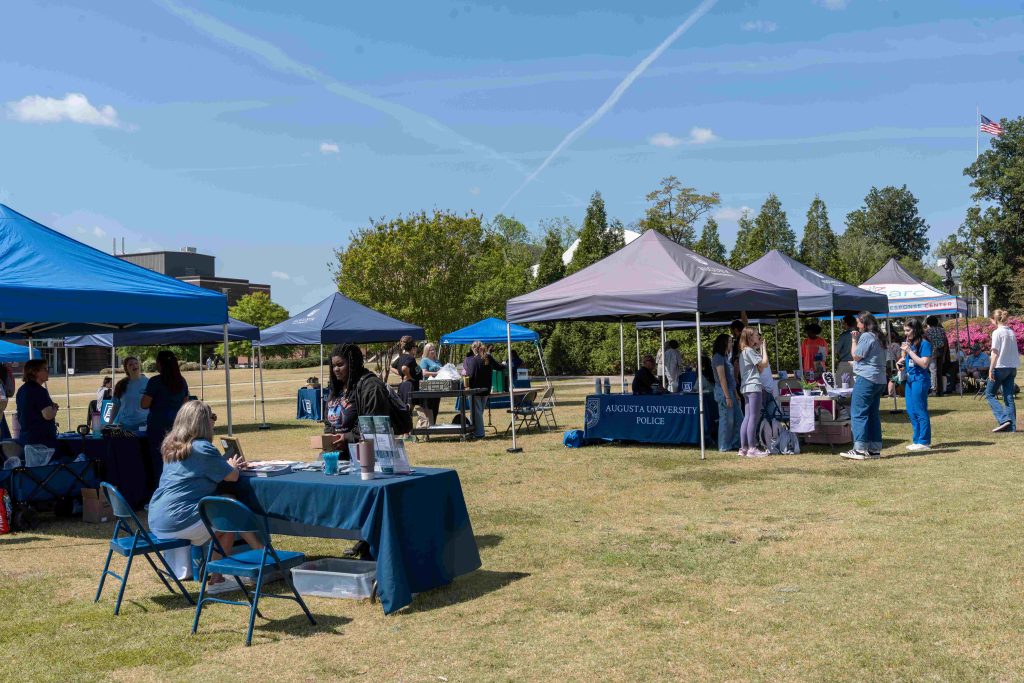 Several tents and tables set up outdoors for an event.
