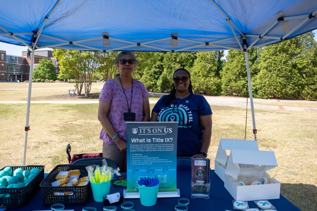 Tabling participants smiling for a photo.