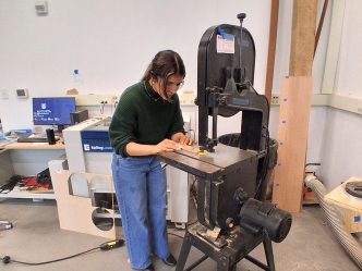 Woman working with a wood cutter