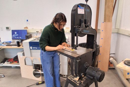 Woman working with a wood cutter