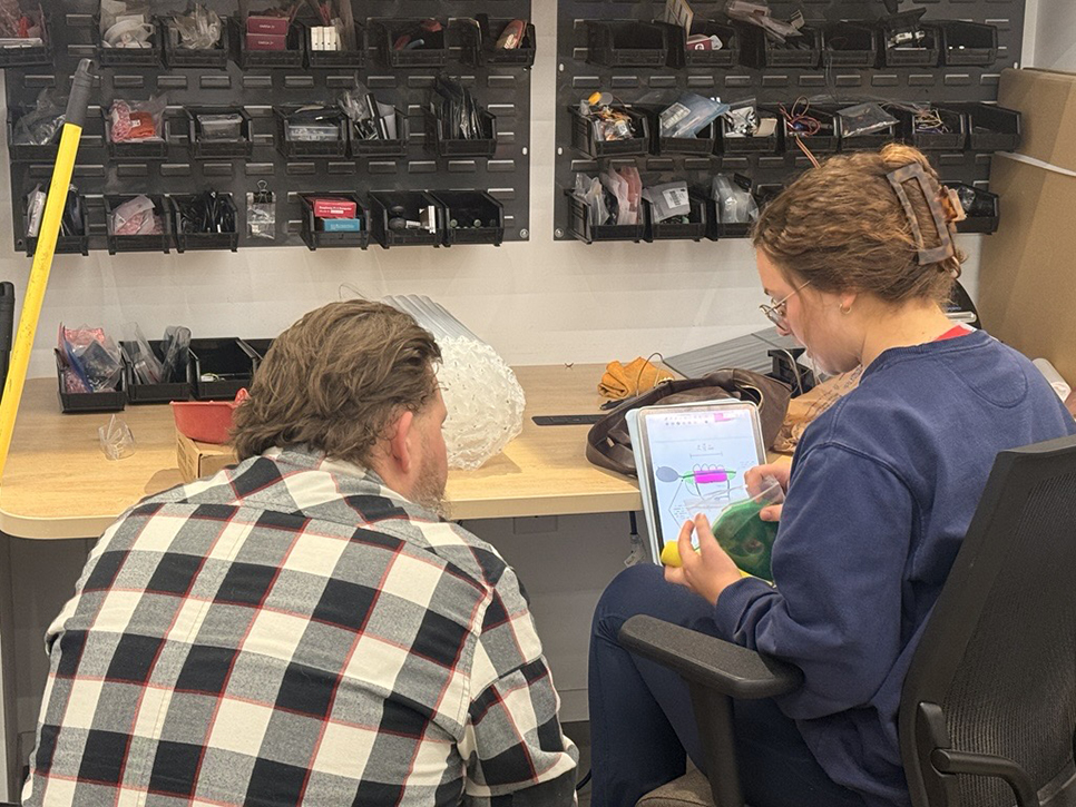 Man and a woman sitting and working at a table