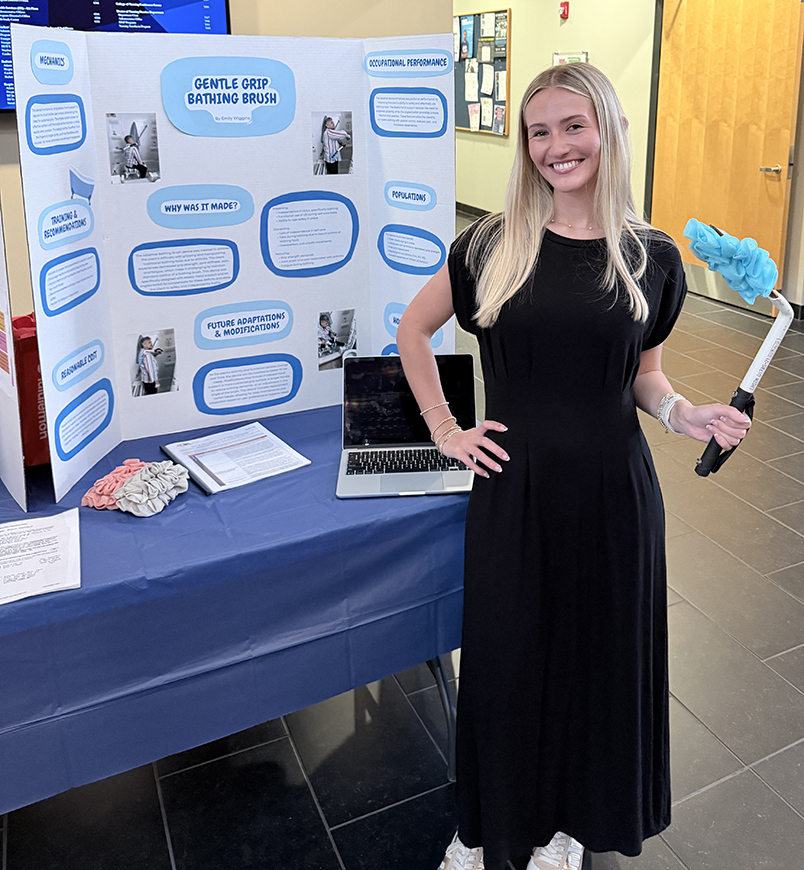 Woman holding a brush standing next to a table