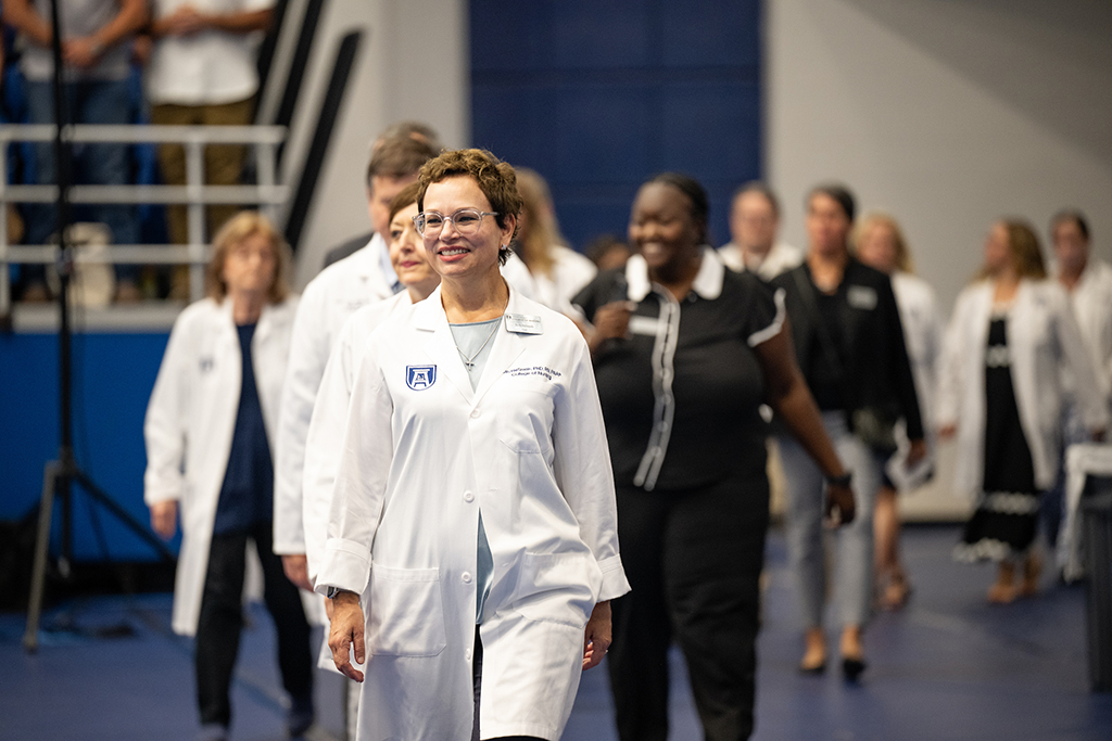 Men and women walking into a ceremony