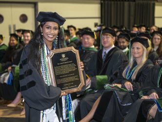 woman holds plaque