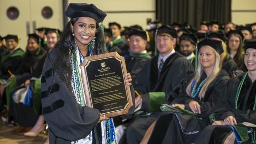 woman holds plaque