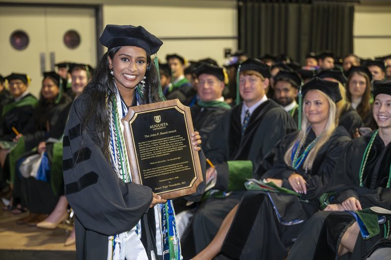 woman holds plaque