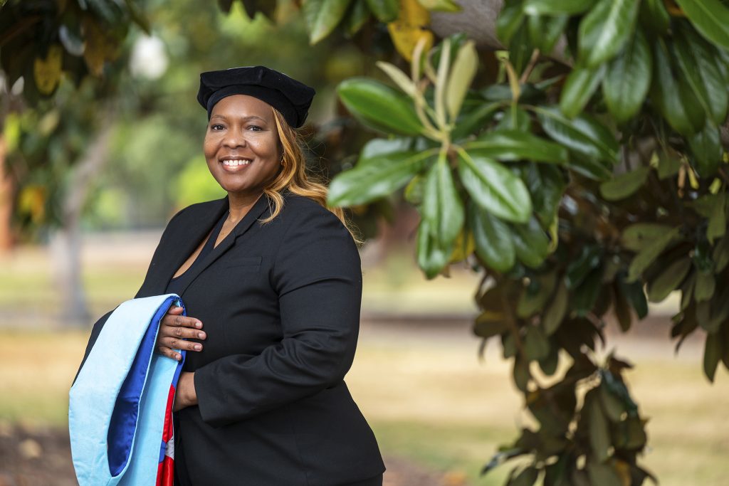 Woman smiling in graduation attire