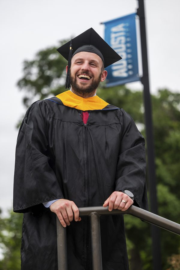 Man smiling in graduation attire