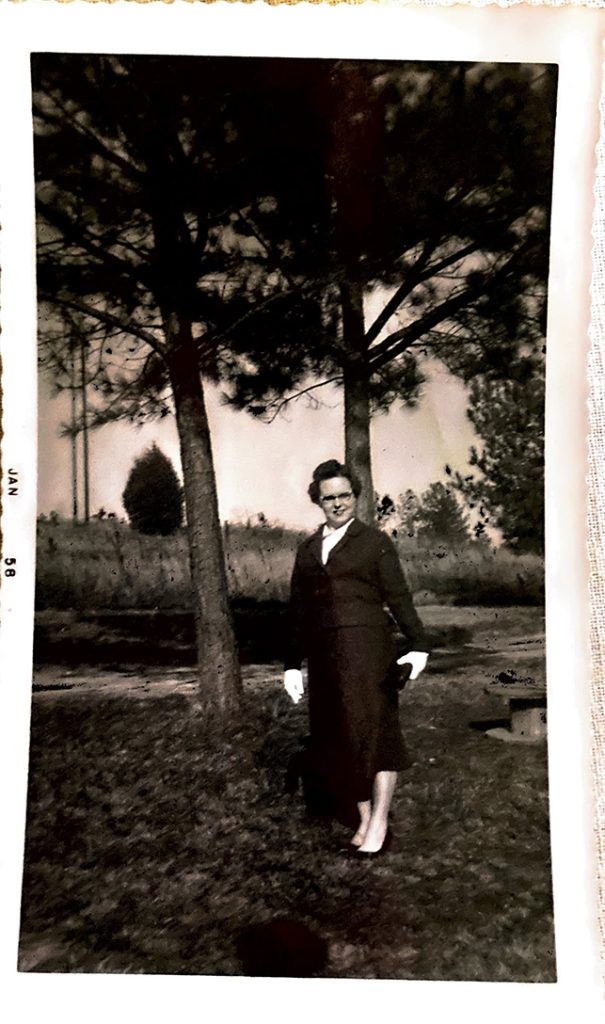 Woman standing near trees