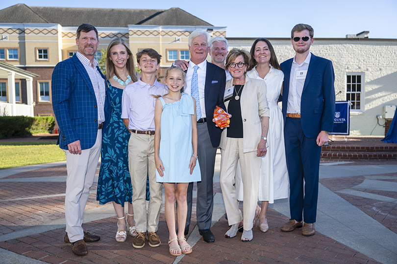 Family smiling after accepting an award