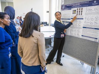 Student explains her research to onlookers