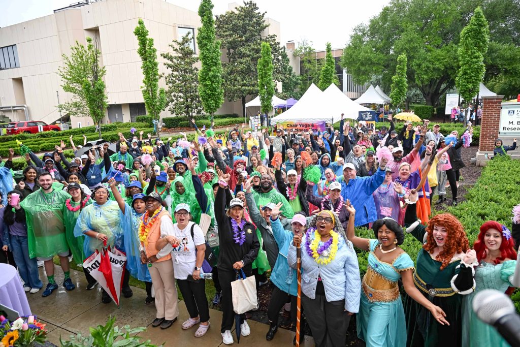 In this photo, you see a large group of people posing for a photo.