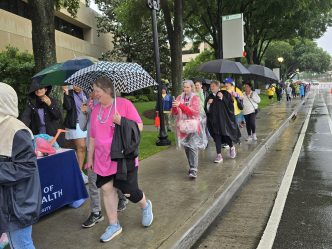 In this photo, you see people walking down a sidewalk. They are participants in the Georgia Cancer Center's Unite in the Fight Against Cancer 2026 community event.