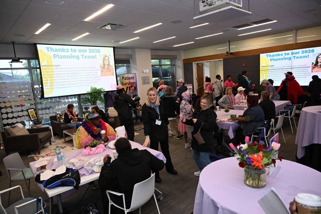 In this photo, you see people standing and sitting inside a Patient VIP Area.
