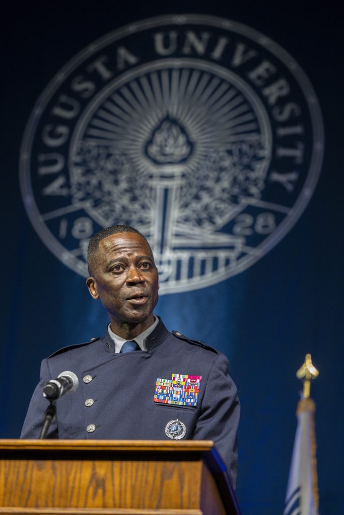 man in a military uniform speaking at a podium