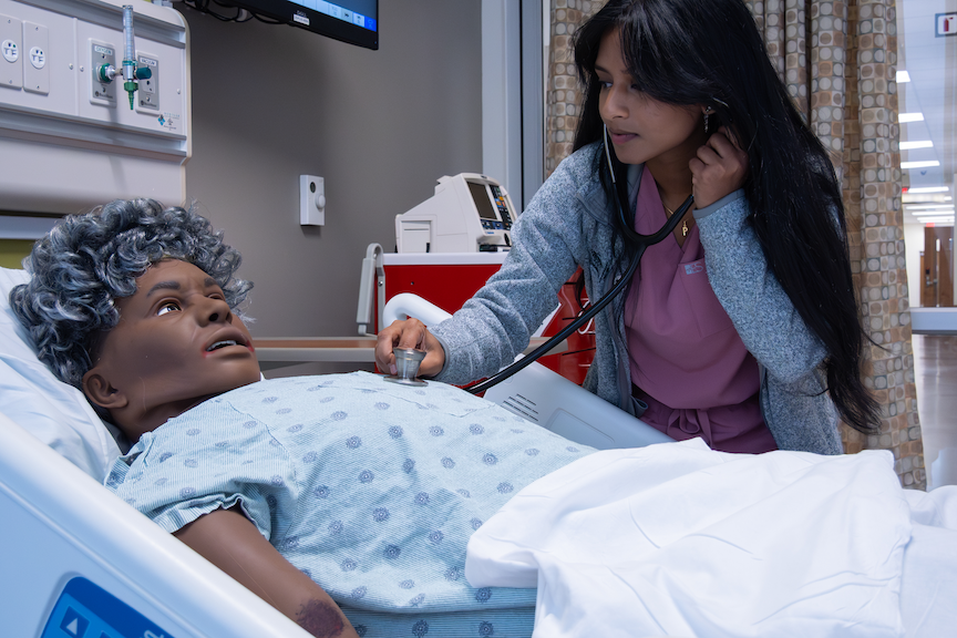 Nurse checking patients heart beat with a stethoscope