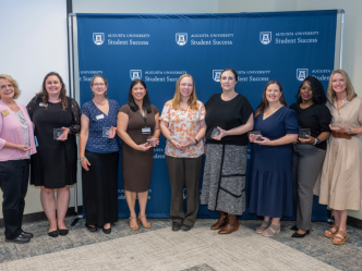 Group of women holding an award.