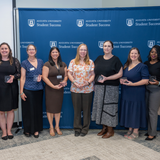 Group of women holding an award.