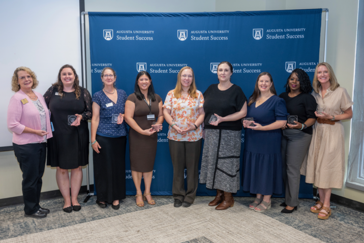 Group of women holding an award.