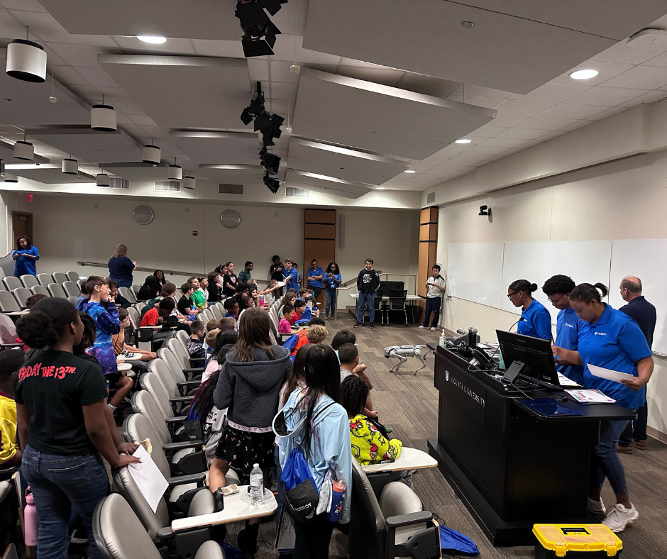 Students watch and interact with a robotic dog demonstration during the VICEROY Kids Coding Camp.