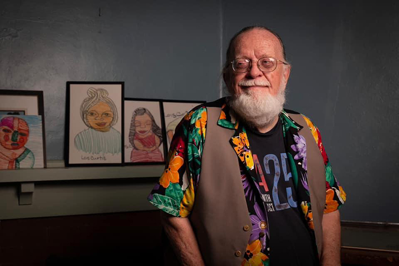 Man in front of framed art