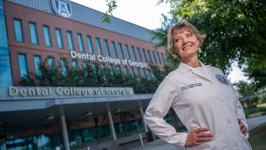 former dean of DCG in front of dental college
