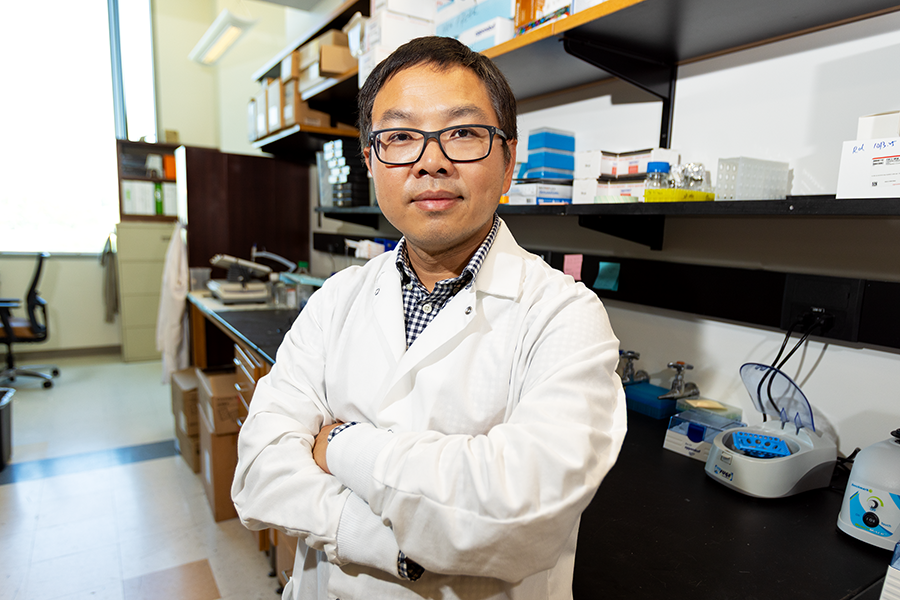 A male scientist standing in a modern research lab.