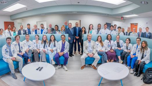Large group of men and women in business dress and medical students in white coats