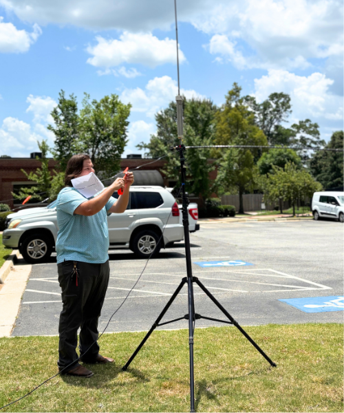 Student sets up antenna for amateur radio event.