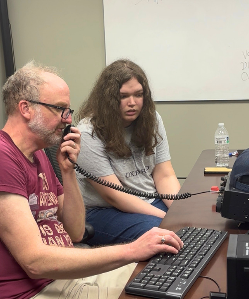 Student learning from instructor during event. 
