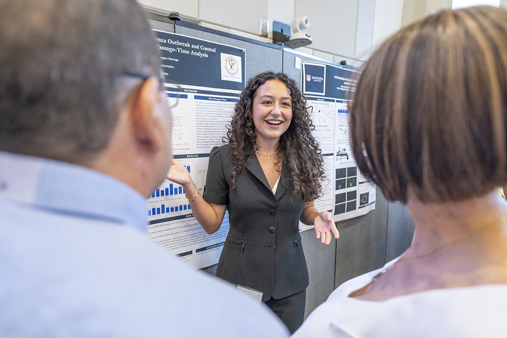 woman standing in front of a poster