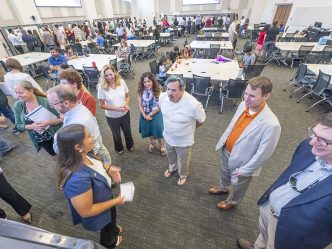 group of people standing and talking to each other.